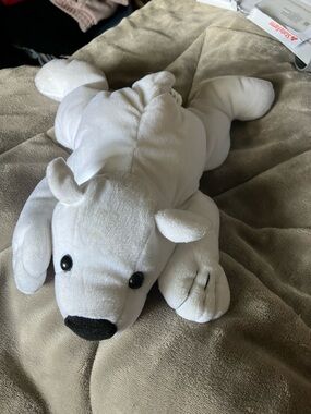 White polar bear Kuddle Me Toys plush toy laying down pillow
